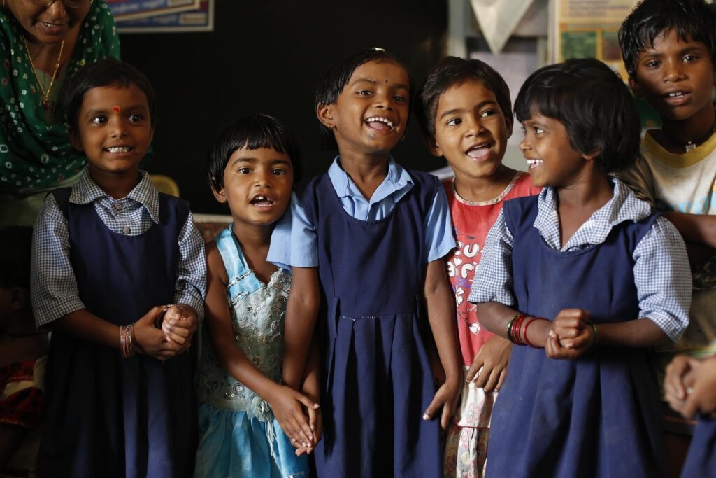 Smiling school children standing together, representing inclusive and values-based education in India